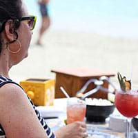 Guest drinking cocktail at the beach